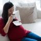 pregnant woman having coffee in living room