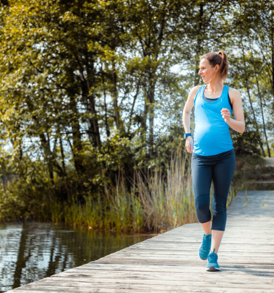active pregnant woman running outdoor, sport during pregnancy