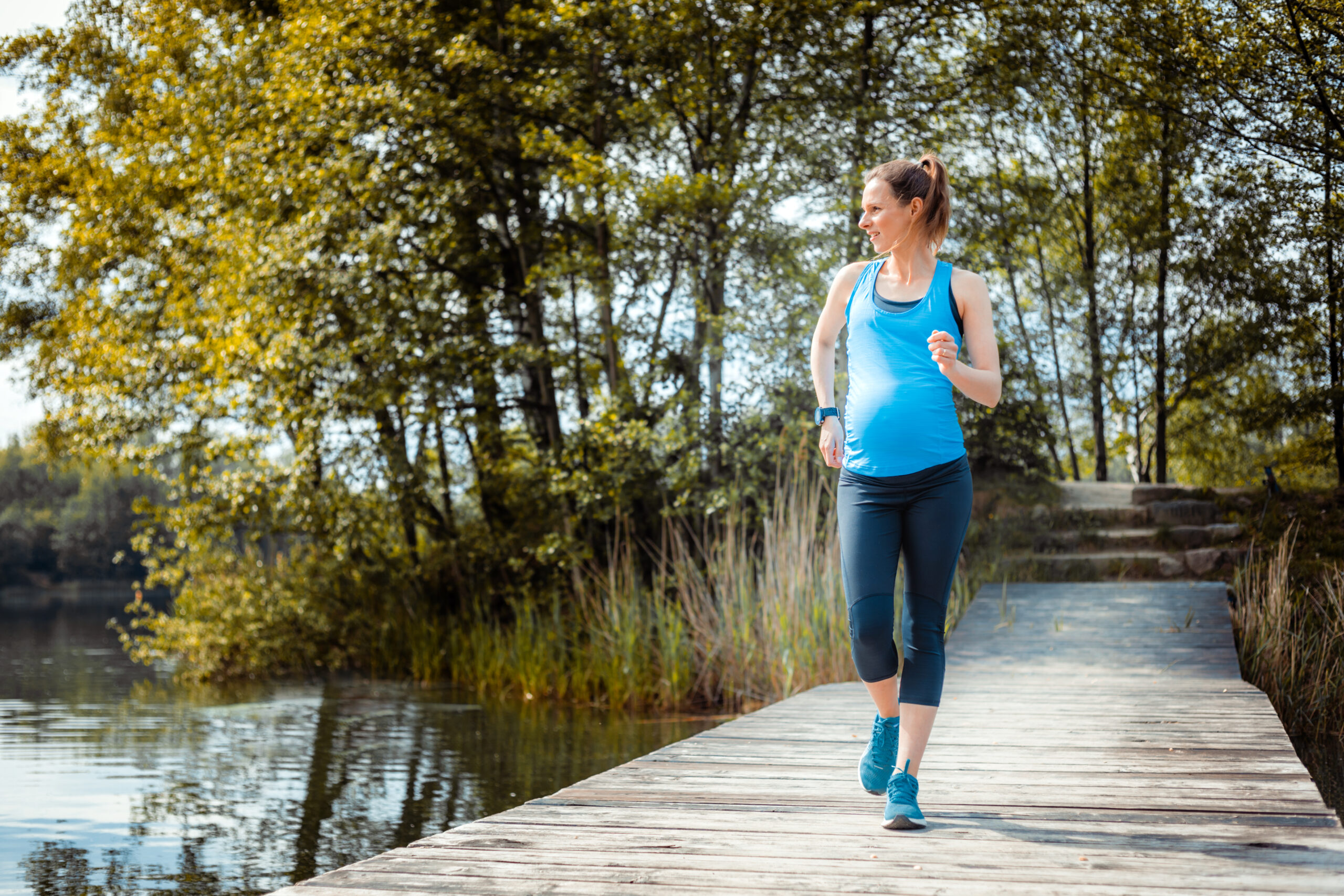 active pregnant woman running outdoor, sport during pregnancy