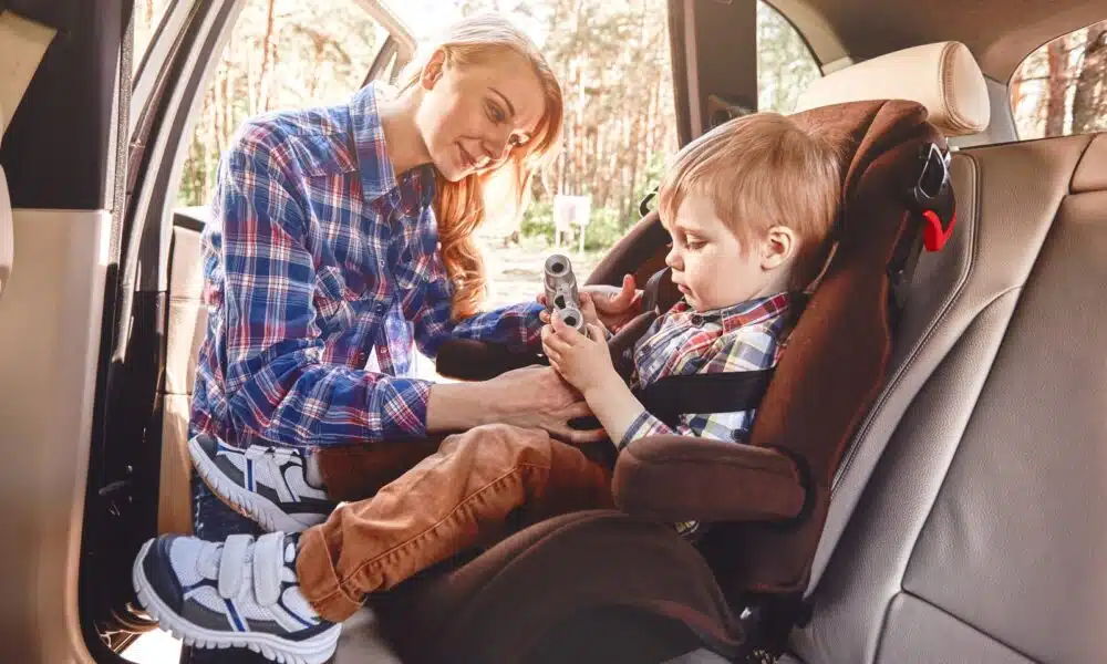 mother fastening her baby boy that sitting in a ca 2025 03 24 23 13 20 utc