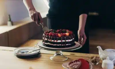 rich chocolate cake with strawberries being cut 2026 03 12 23 56 11 utc