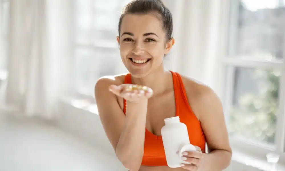 sports woman takes supplements or vitamins at gym 2026 03 25 00 19 09 utc