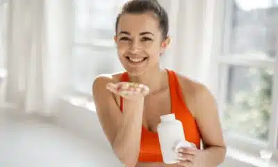 sports woman takes supplements or vitamins at gym 2026 03 25 00 19 09 utc