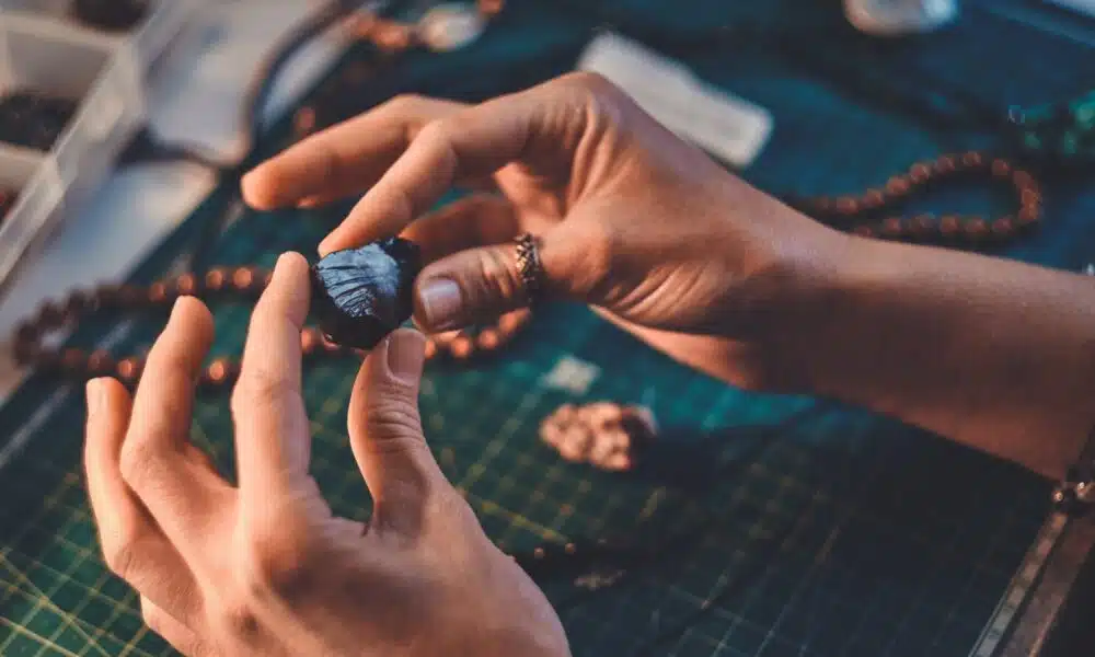 hands holding shiny stone for artistic jewelry des 2026 03 17 03 29 50 utc