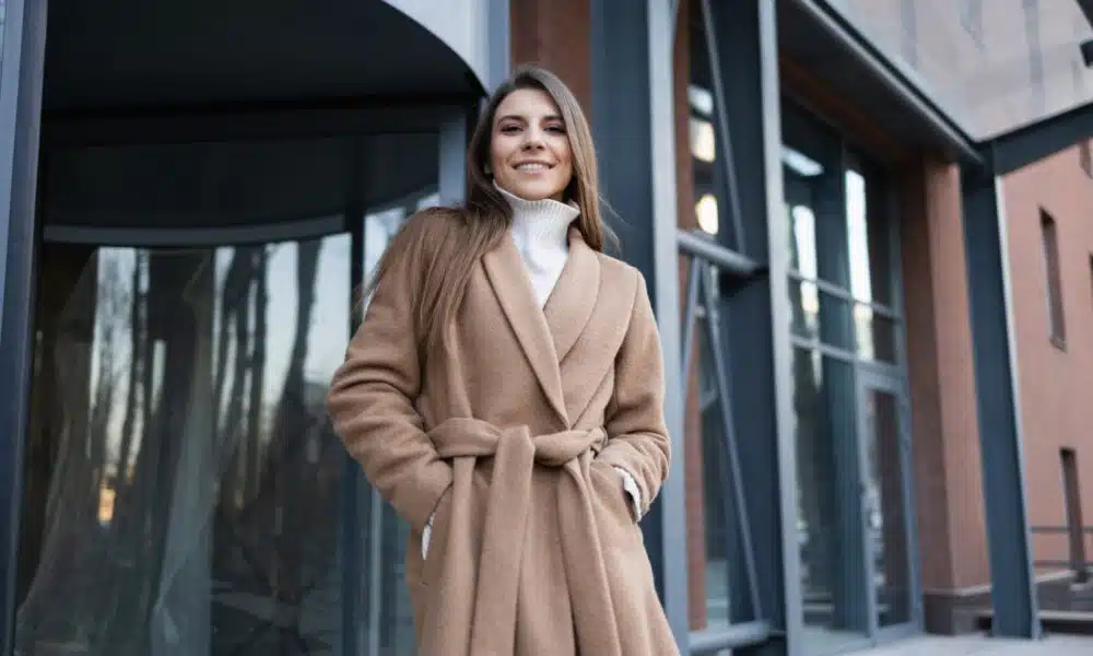 stylish woman in coat posing outside building 2026 01 05 06 06 30 utc