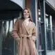 stylish woman in coat posing outside building 2026 01 05 06 06 30 utc